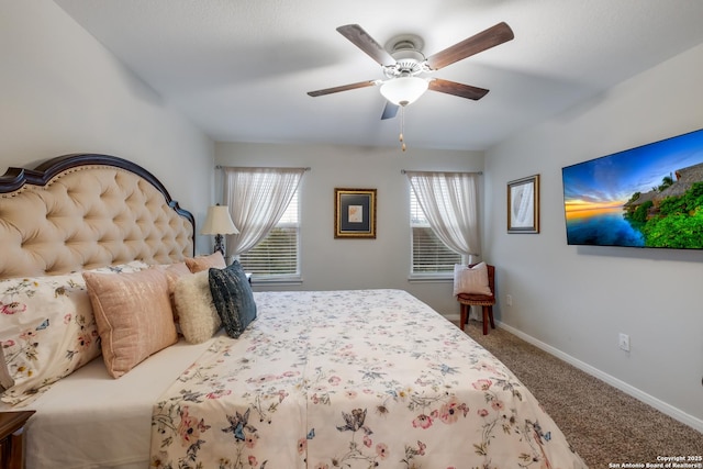 bedroom featuring carpet flooring, multiple windows, a ceiling fan, and baseboards