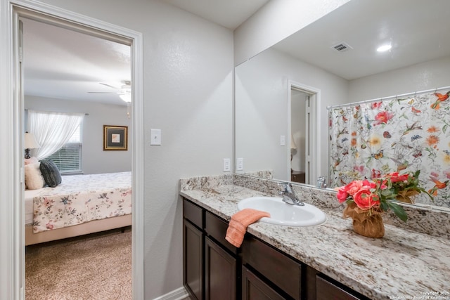 bathroom with a shower with curtain, ceiling fan, and vanity