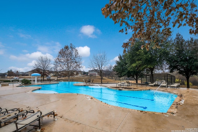 view of swimming pool with a patio area