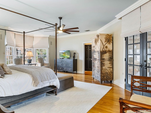 bedroom with ornamental molding, light hardwood / wood-style floors, french doors, and ceiling fan