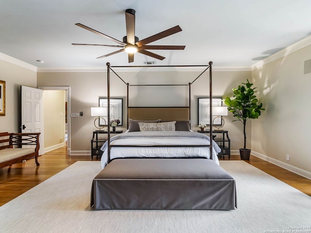 bedroom with crown molding and hardwood / wood-style floors