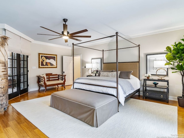 bedroom with hardwood / wood-style flooring, ornamental molding, and french doors