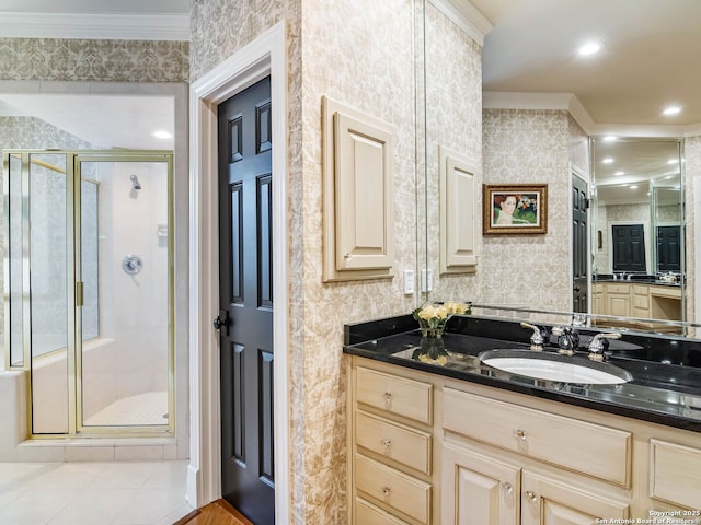 bathroom featuring vanity, tile patterned flooring, crown molding, and a shower with shower door