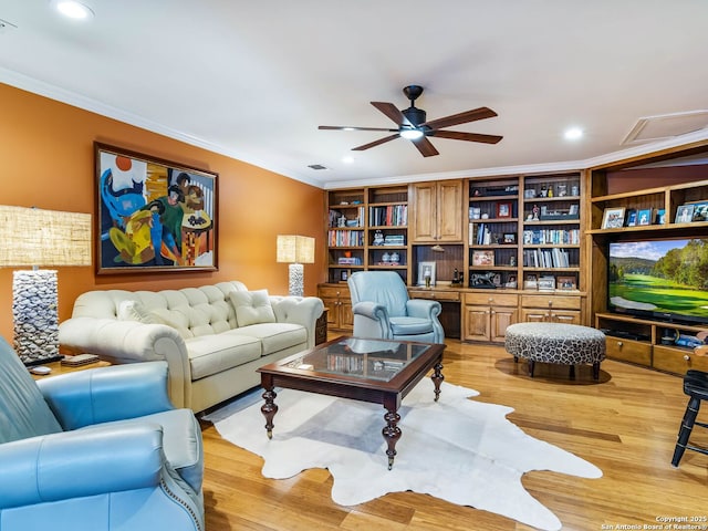 living room with ornamental molding, light hardwood / wood-style floors, and ceiling fan