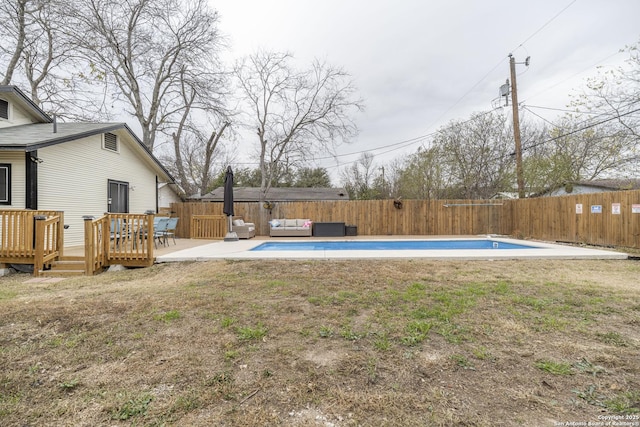 view of yard featuring outdoor lounge area, a pool side deck, and a patio area