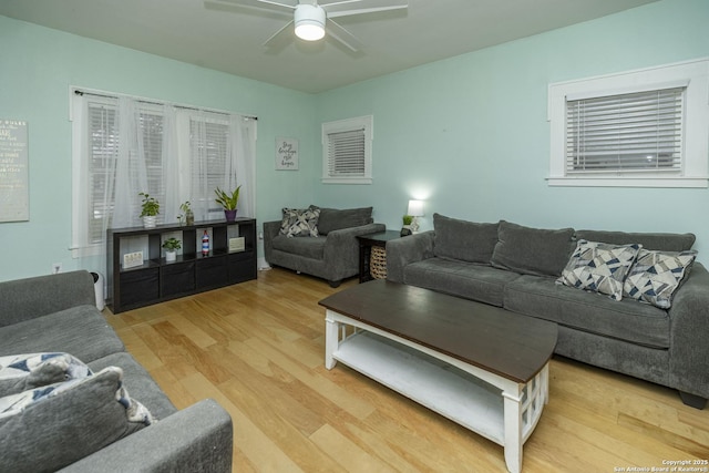 living room featuring ceiling fan and light wood-type flooring