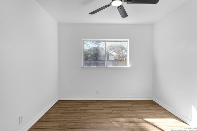 spare room with hardwood / wood-style flooring and ceiling fan