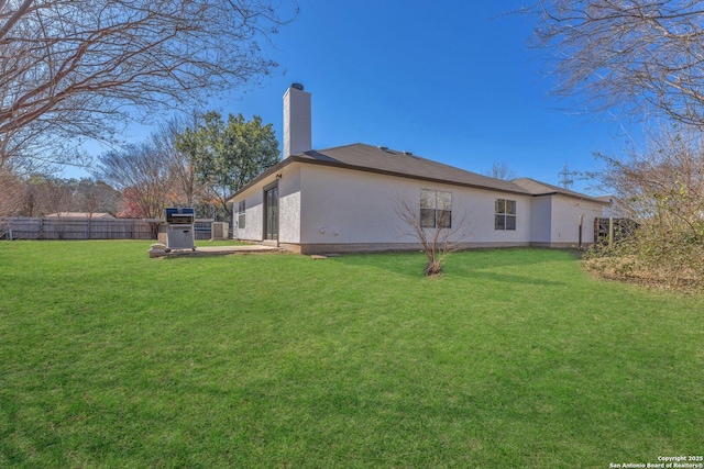 view of side of home featuring a lawn