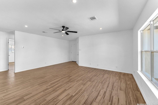 empty room featuring ceiling fan and light wood-type flooring