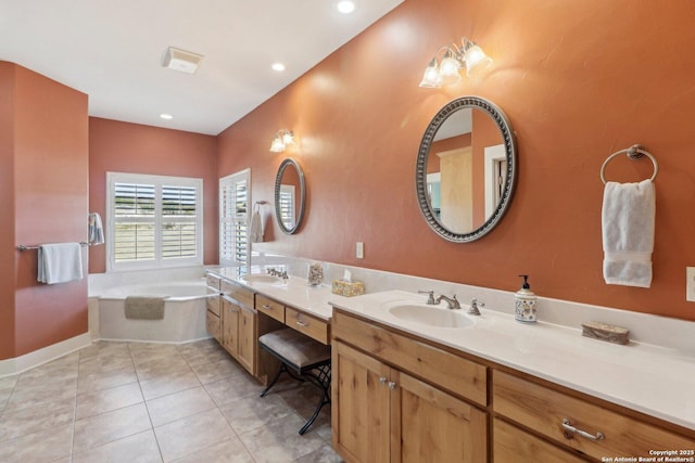 bathroom featuring tile patterned flooring, vanity, and a tub