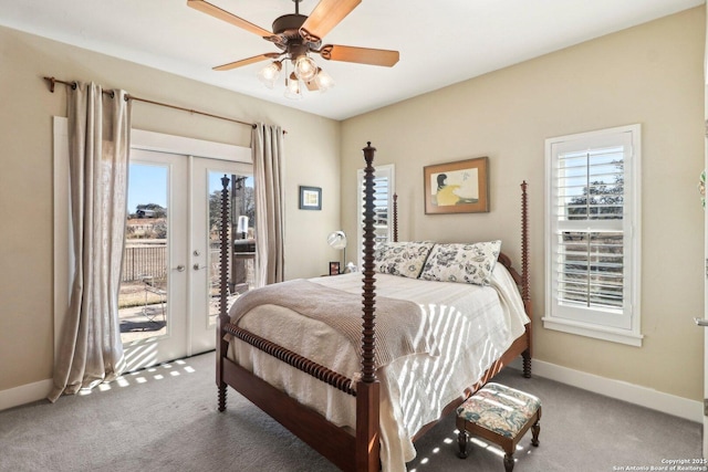 carpeted bedroom featuring french doors, ceiling fan, multiple windows, and access to outside