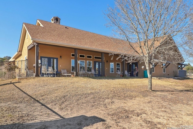 back of house with central AC