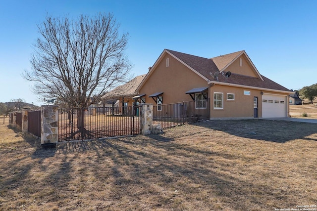 view of home's exterior with a garage and a lawn