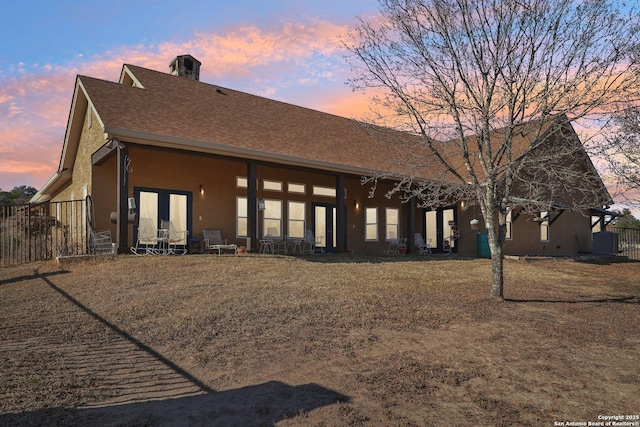 back house at dusk with a yard