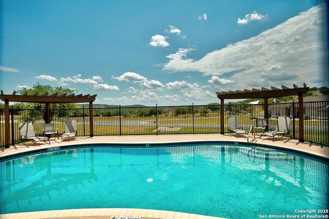 view of swimming pool with a pergola