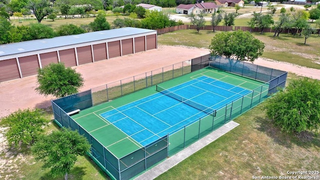 view of sport court with a yard