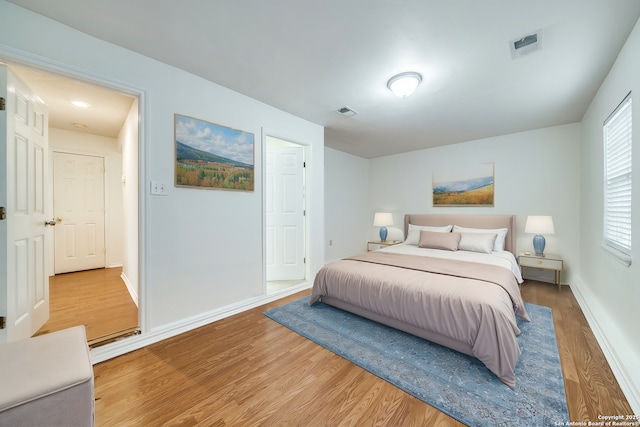 bedroom with hardwood / wood-style flooring