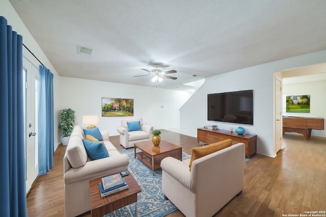 living room with ceiling fan and light wood-type flooring