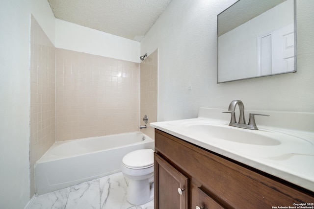 full bathroom featuring vanity, tiled shower / bath, toilet, and a textured ceiling