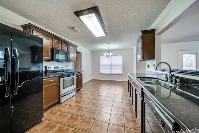 kitchen featuring sink, light tile patterned floors, a notable chandelier, black appliances, and a textured ceiling