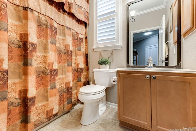 bathroom featuring tile patterned flooring, crown molding, vanity, and toilet