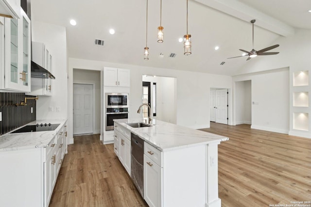 kitchen featuring white cabinetry, a kitchen island with sink, sink, and black appliances