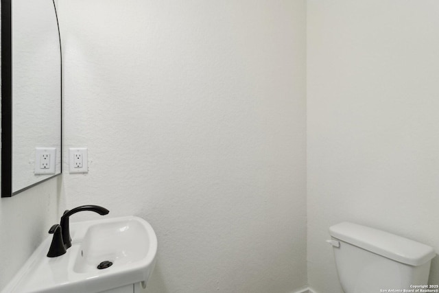 bathroom with toilet and sink