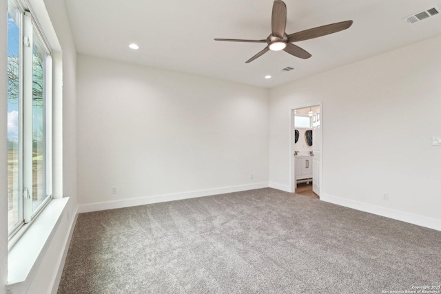 unfurnished room featuring dark carpet and ceiling fan