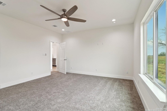 carpeted empty room with ceiling fan and a healthy amount of sunlight