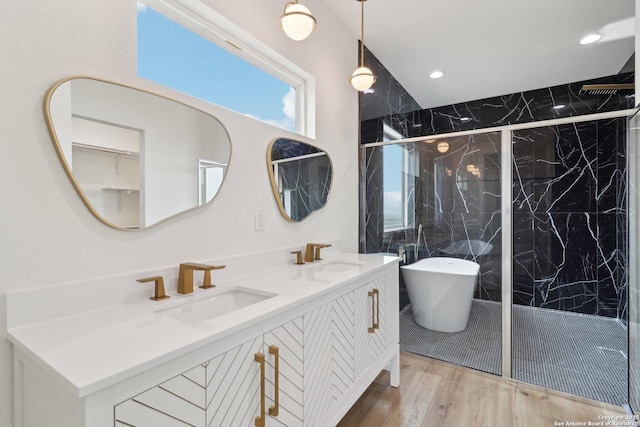 bathroom featuring vanity, separate shower and tub, and wood-type flooring