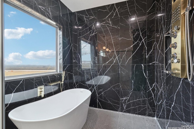 bathroom featuring tile walls and a bathtub