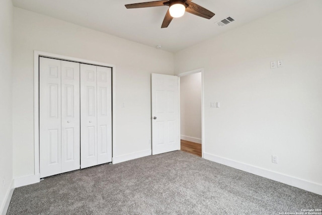 unfurnished bedroom with carpet floors, a closet, and ceiling fan