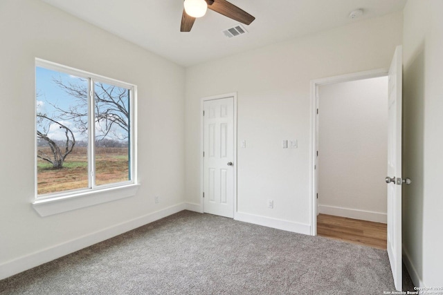 unfurnished bedroom featuring ceiling fan and carpet flooring