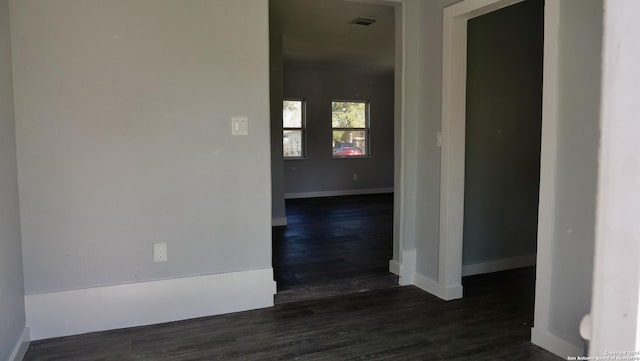 empty room featuring dark hardwood / wood-style flooring