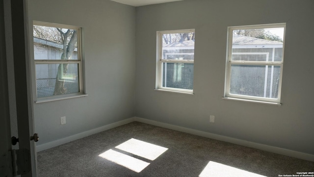 carpeted empty room with a healthy amount of sunlight