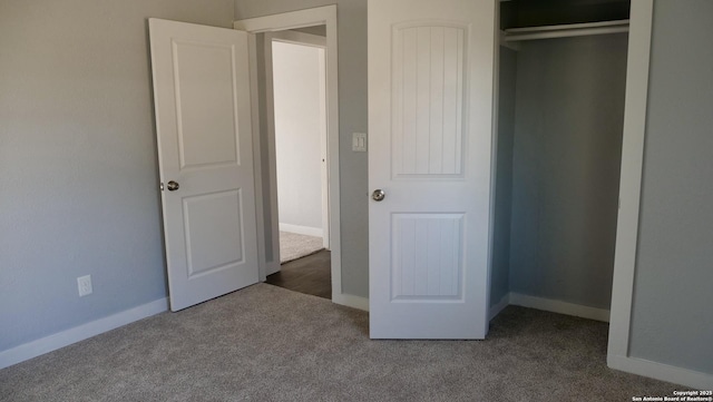 unfurnished bedroom featuring dark colored carpet