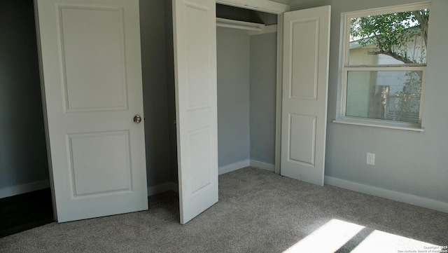 unfurnished bedroom featuring light colored carpet