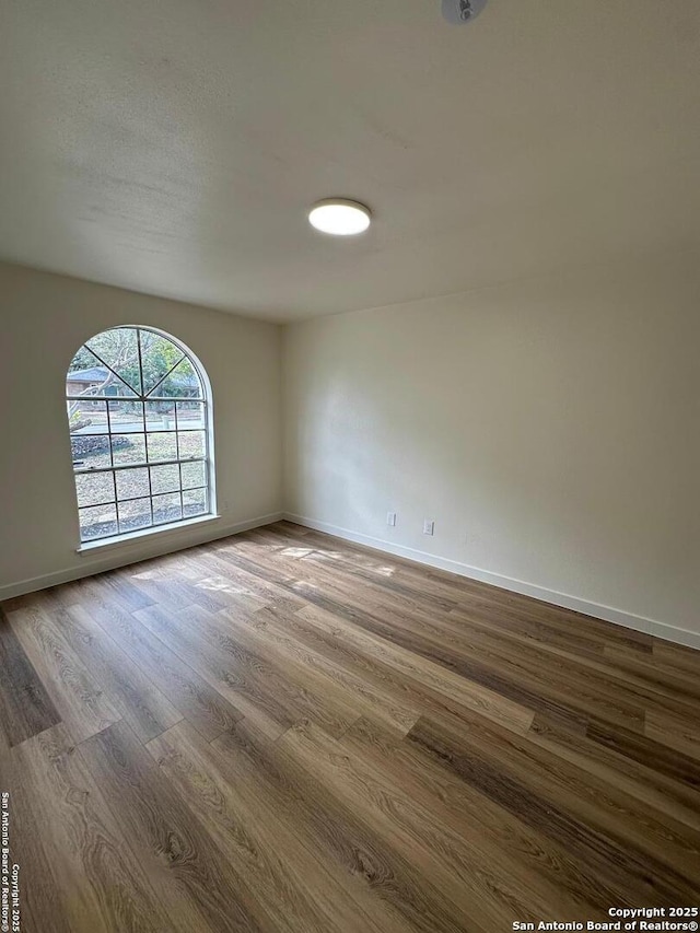 spare room with hardwood / wood-style floors