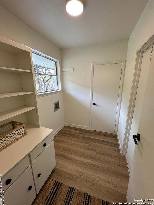 interior space with cabinets, washer hookup, and dark hardwood / wood-style flooring