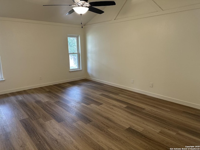 empty room featuring ceiling fan, lofted ceiling, and dark hardwood / wood-style flooring