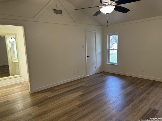 unfurnished room with vaulted ceiling, dark hardwood / wood-style floors, and ceiling fan