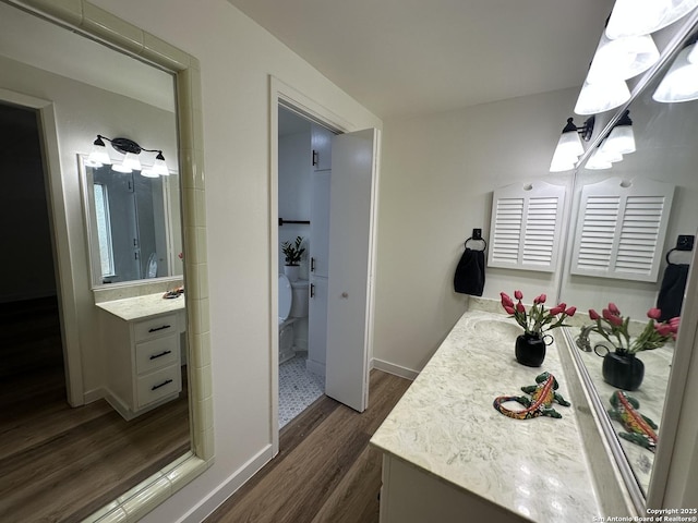 bathroom with vanity, hardwood / wood-style floors, and toilet