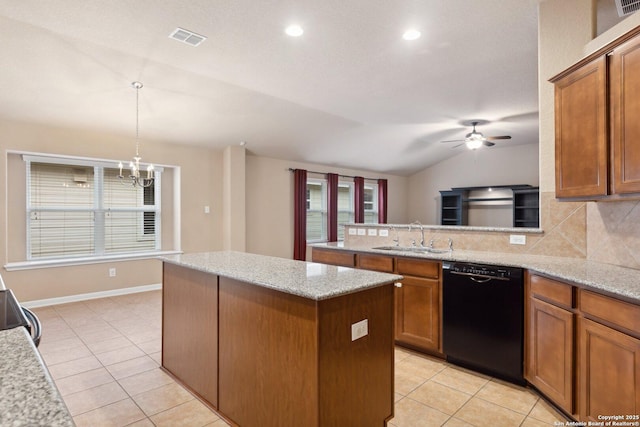 kitchen featuring vaulted ceiling, decorative light fixtures, black dishwasher, sink, and light stone countertops