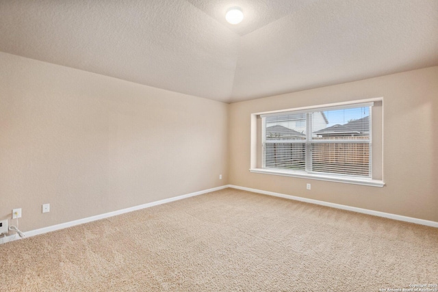 carpeted spare room with a textured ceiling