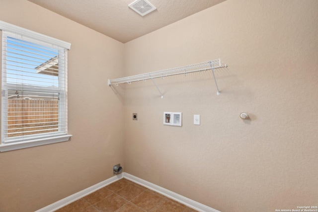 washroom featuring hookup for a washing machine, hookup for an electric dryer, and tile patterned floors