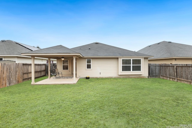 rear view of property with a yard and a patio