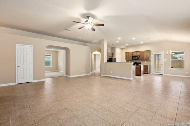 unfurnished living room featuring light tile patterned flooring, lofted ceiling, and ceiling fan with notable chandelier