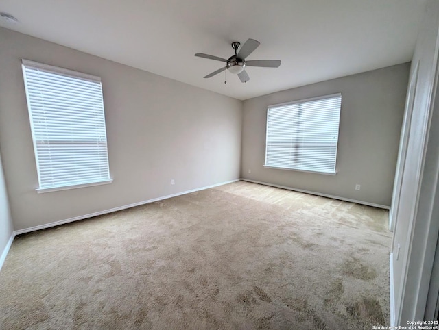 spare room with light carpet and ceiling fan