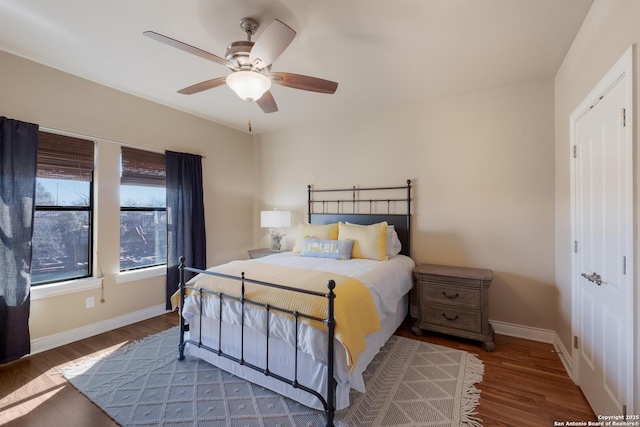 bedroom with dark wood-type flooring and ceiling fan