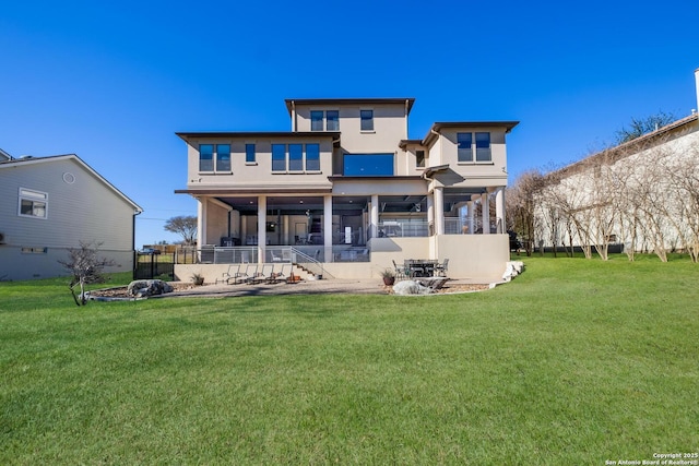 rear view of property featuring a lawn